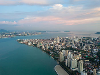 High angle view of buildings by sea against sky