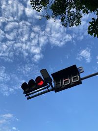 Low angle view of road signal against blue sky