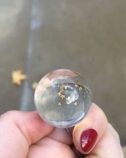 Close-up of hand holding crystal ball