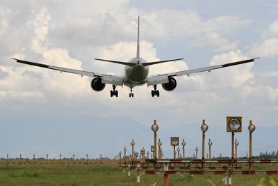 Low angle view of airplane flying against sky