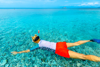 High angle view of woman snorkeling in sea