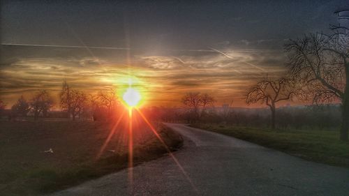 Road against dramatic sky during sunset