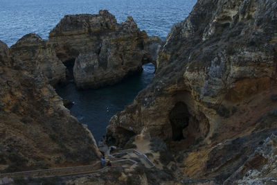 High angle view of rocks on sea shore