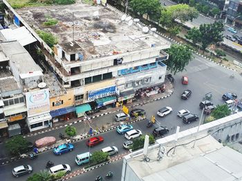 High angle view of traffic on road amidst buildings in city