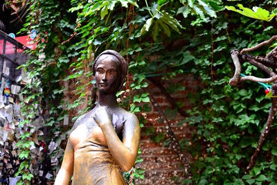 Low angle view of statue against trees in forest