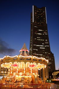 Low angle view of illuminated building against sky at night