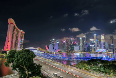 High angle view of illuminated buildings against sky at night