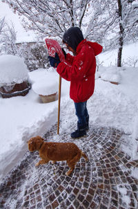 Full length of woman standing on snow during winter