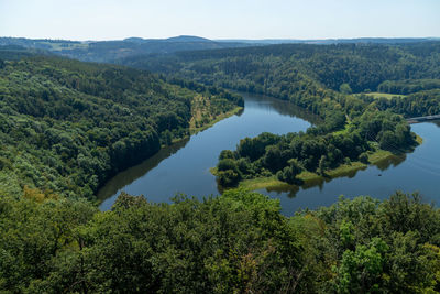 High angle view of lake in forest against sky