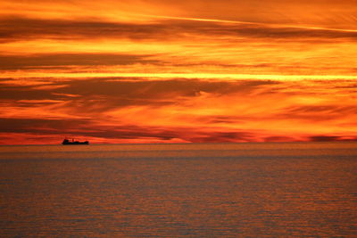 Scenic view of sea against dramatic sky