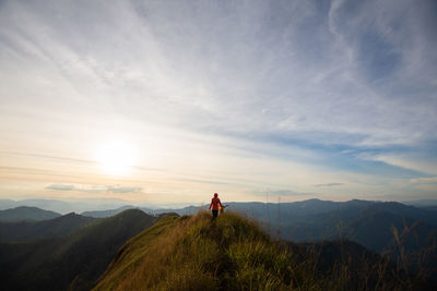 Man standing on mountain against sky