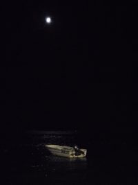 Scenic view of sea against clear sky at night