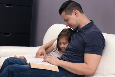 Mother and daughter on book