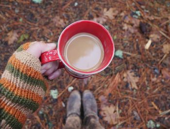 Low section of person holding coffee cup