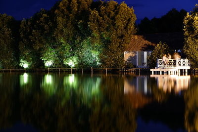 Scenic view of lake against sky at night