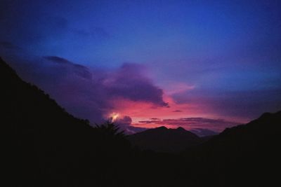 Scenic view of silhouette mountains against sky at sunset