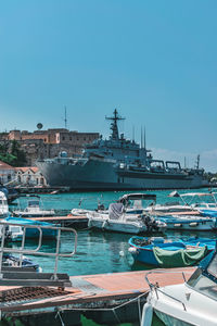 View of marina at harbor against blue sky