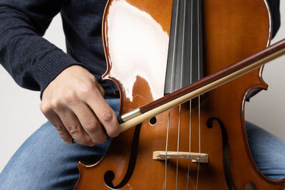 Midsection of man playing guitar