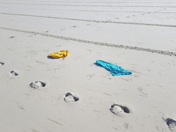 High angle view of footprints on sand at beach