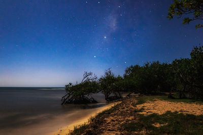 Scenic view of beach against sky at night