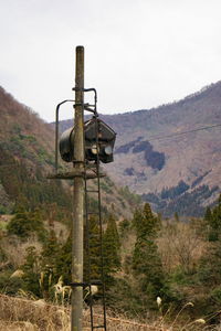 Traditional windmill on field against sky