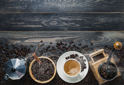 Close-up of coffee beans and maker on table