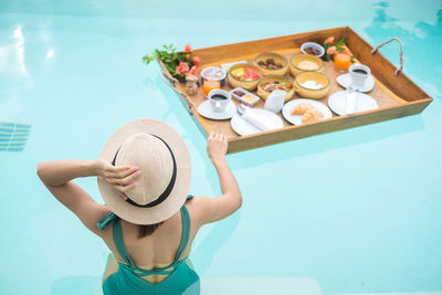 High angle view of woman by swimming pool