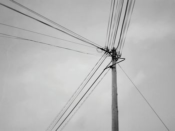 Low angle view of electricity pylon against sky