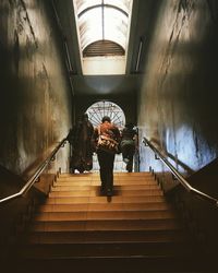 Rear view of woman walking on staircase