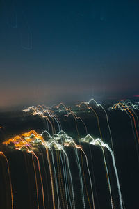 Light trails against sky at night