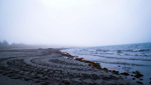 Scenic view of beach against clear sky