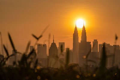 Modern buildings in city during sunset