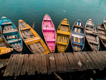 High angle view of multi colored boats moored at pier