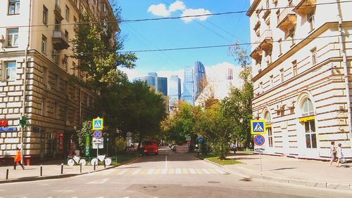 Street amidst buildings against sky in city