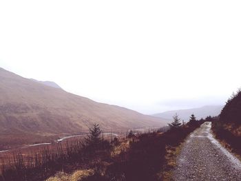 Road amidst landscape against clear sky