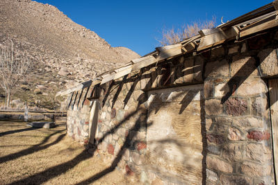 View of empty stone bathhouse against clear sky