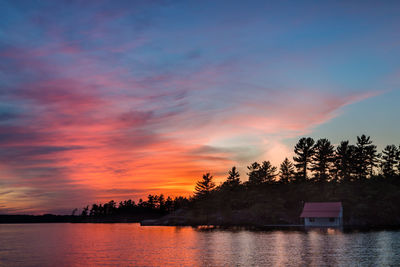 Scenic view of lake against sky during sunset