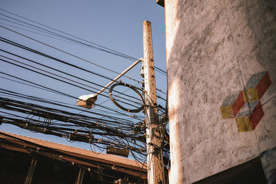 Low angle view of electricity pylon against sky