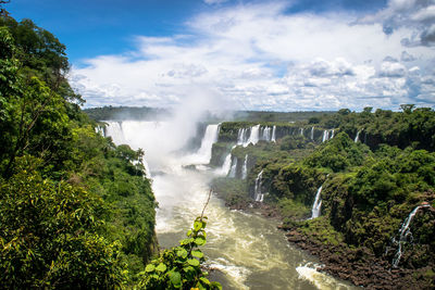 Scenic view of waterfall against sky