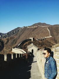 Young man standing on great wall of china