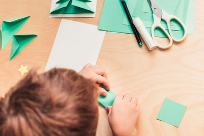 High angle portrait of woman holding paper