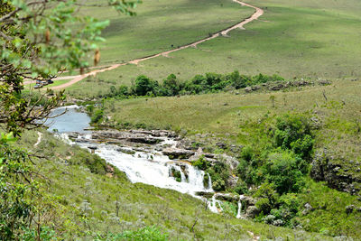 High angle view of stream amidst field