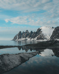 Scenic view of lake and mountains against sky