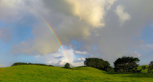 Rainbow over landscape against sky