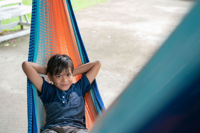 Portrait of boy relaxing on hammock