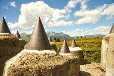 Panoramic view of tourists on mountain against cloudy sky