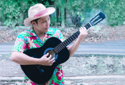 Mature man playing acoustic guitar