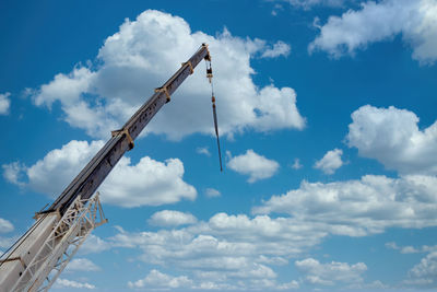 Low angle view of crane against sky