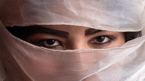 Close-up portrait of woman covering face