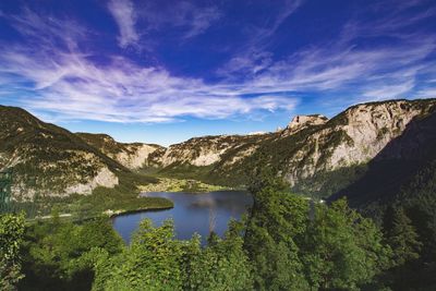 Scenic view of lake and mountains against blue sky